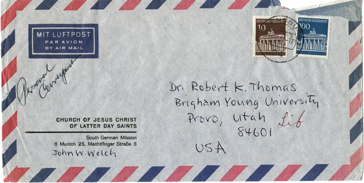 Photograph of the front of an airmail envelope addressed to Robert K. Thomas at Brigham Young University, with postage stamps and postal markings visible.