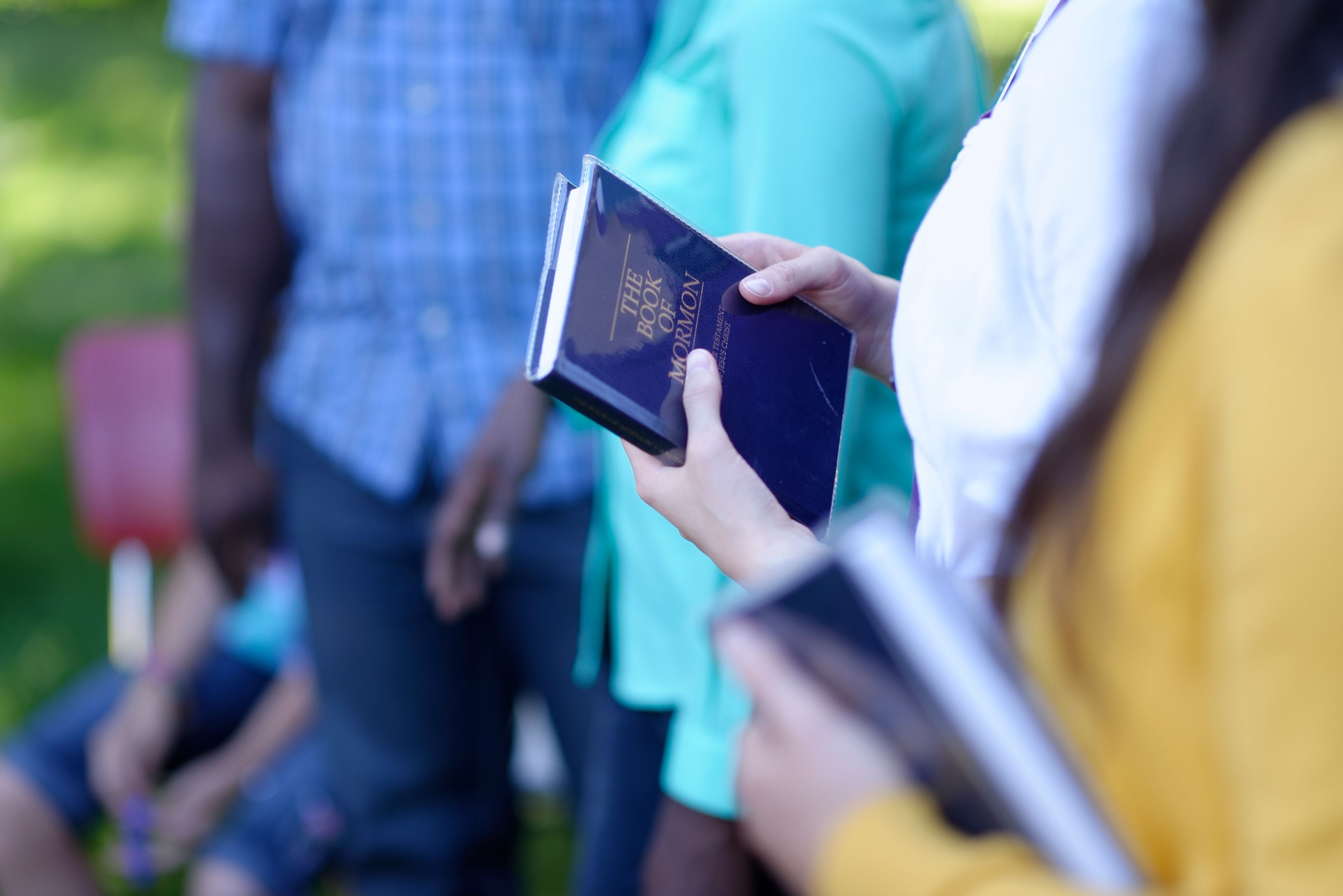 An image of the Book of Mormon in a woman's hands.